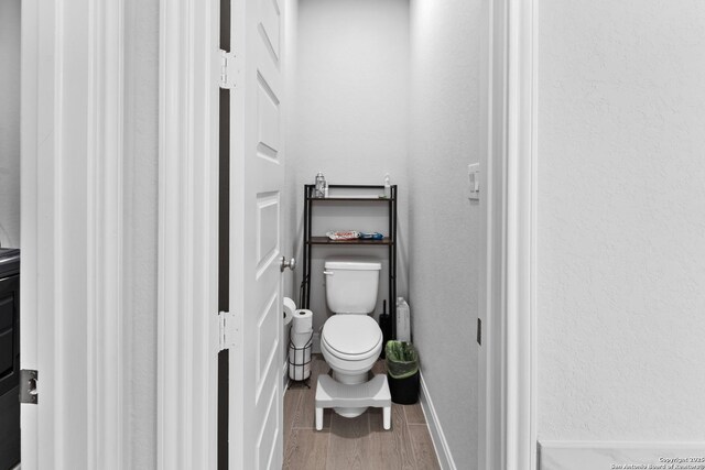 bathroom featuring toilet and hardwood / wood-style flooring