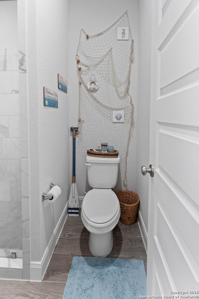 bathroom featuring toilet and wood-type flooring