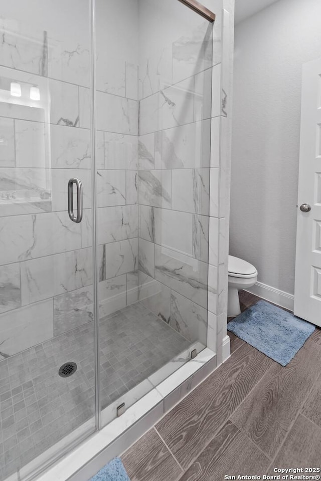 bathroom featuring walk in shower and toilet