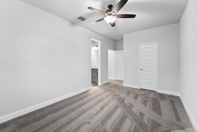 unfurnished bedroom featuring ceiling fan, connected bathroom, a closet, and carpet