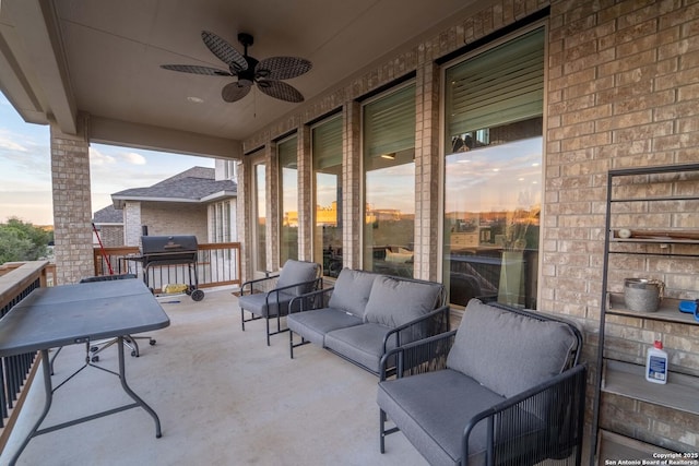 patio terrace at dusk with ceiling fan, a grill, and an outdoor living space