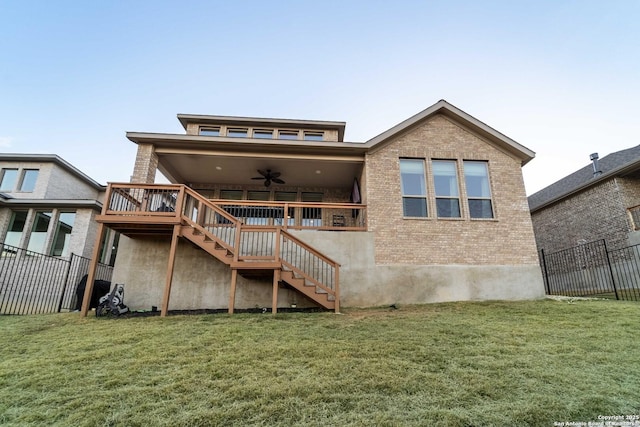 back of house featuring ceiling fan, a deck, and a yard