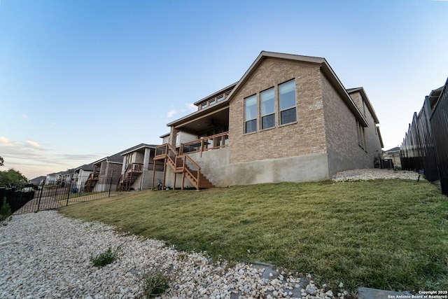 property exterior at dusk featuring a lawn