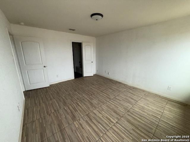 empty room with hardwood / wood-style flooring