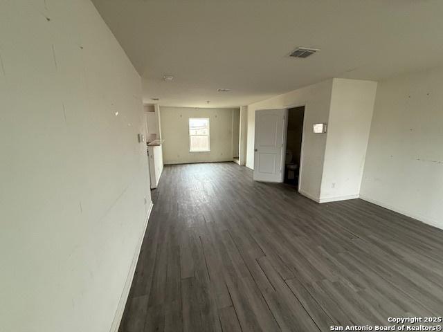 spare room with dark hardwood / wood-style floors