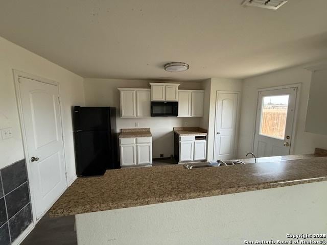 kitchen with sink, white cabinets, and black appliances