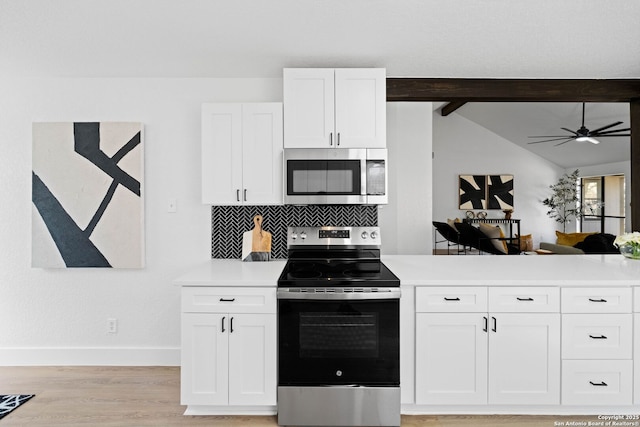 kitchen with appliances with stainless steel finishes, tasteful backsplash, light wood-type flooring, white cabinets, and lofted ceiling with beams