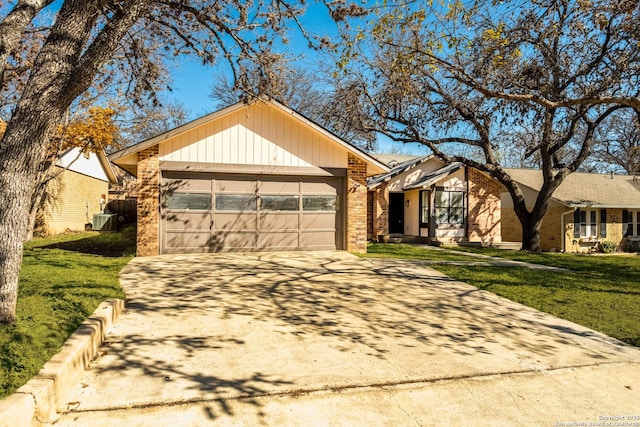 ranch-style home with a front yard, a garage, and central air condition unit