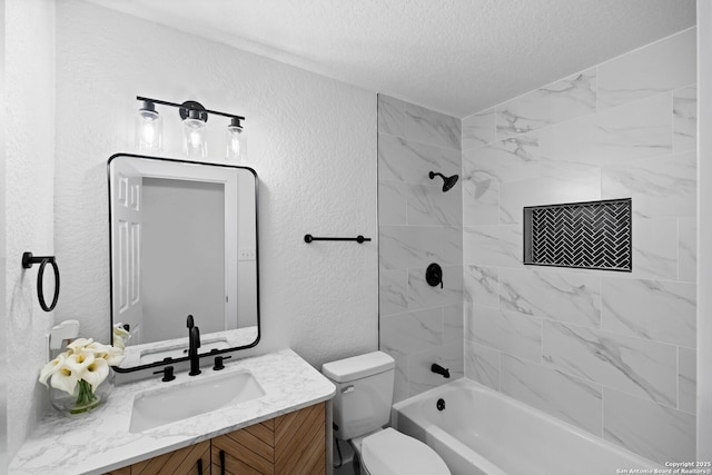 full bathroom with a textured ceiling, toilet, tiled shower / bath combo, and vanity