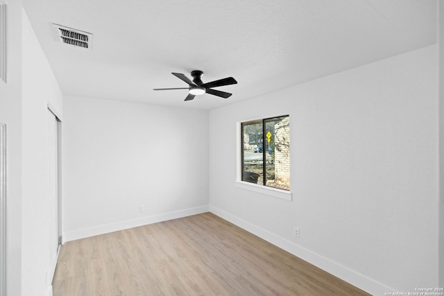 empty room with ceiling fan and light wood-type flooring