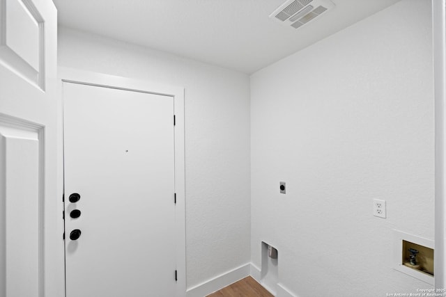 clothes washing area with washer hookup, hookup for an electric dryer, and light hardwood / wood-style flooring