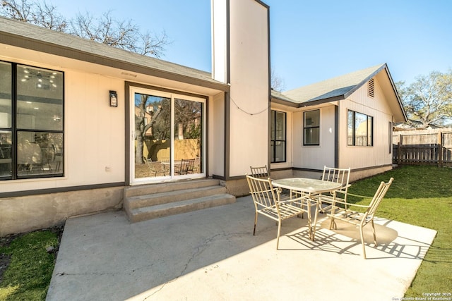 back of property featuring a yard and a patio