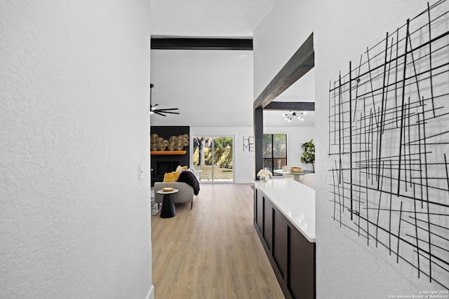 hall featuring beam ceiling, a chandelier, and light hardwood / wood-style floors