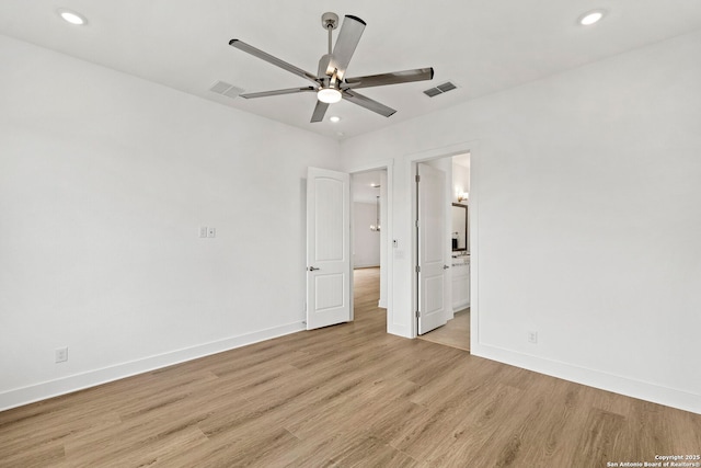 unfurnished bedroom featuring ceiling fan, ensuite bathroom, and light hardwood / wood-style floors