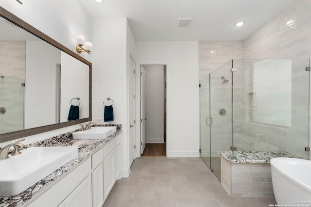 bathroom featuring tile patterned floors, vanity, and independent shower and bath