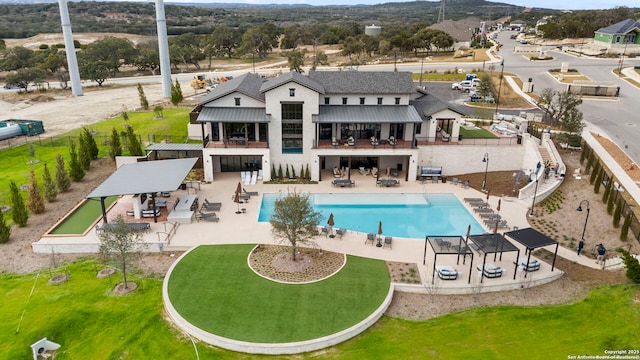 back of house with a patio area and a community pool