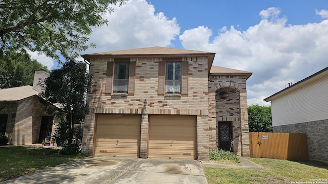 view of front facade with a garage, concrete driveway, fence, and stone siding