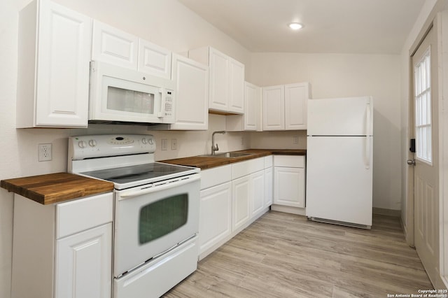 kitchen featuring butcher block countertops, sink, white appliances, white cabinetry, and light wood-type flooring