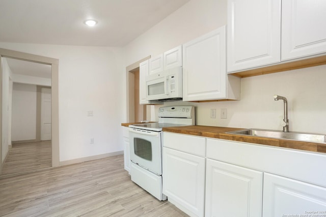 kitchen featuring sink, white cabinets, butcher block countertops, and white appliances