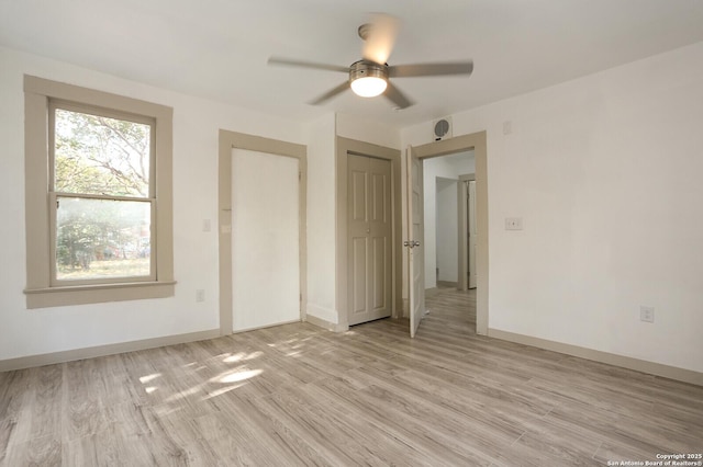 unfurnished bedroom featuring ceiling fan, a closet, and light hardwood / wood-style floors