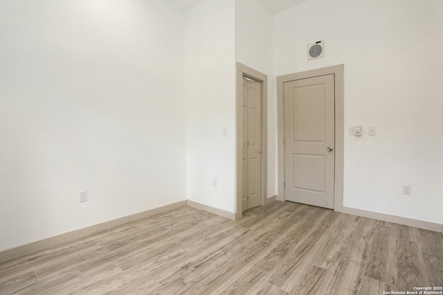 spare room featuring light wood-type flooring