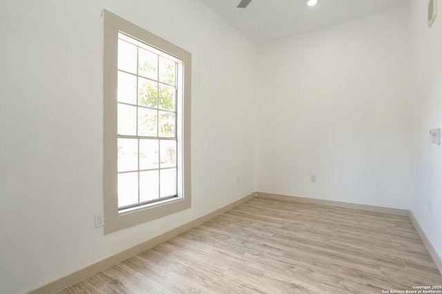 spare room featuring ceiling fan and light wood-type flooring