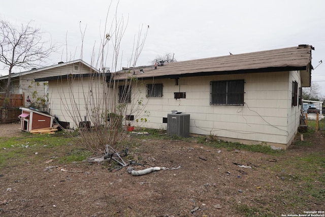 back of property featuring central AC