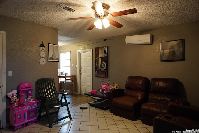 tiled living room with ceiling fan, a textured ceiling, and a wall mounted air conditioner