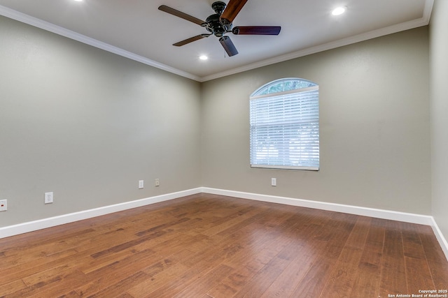 empty room featuring hardwood / wood-style flooring, ornamental molding, and ceiling fan