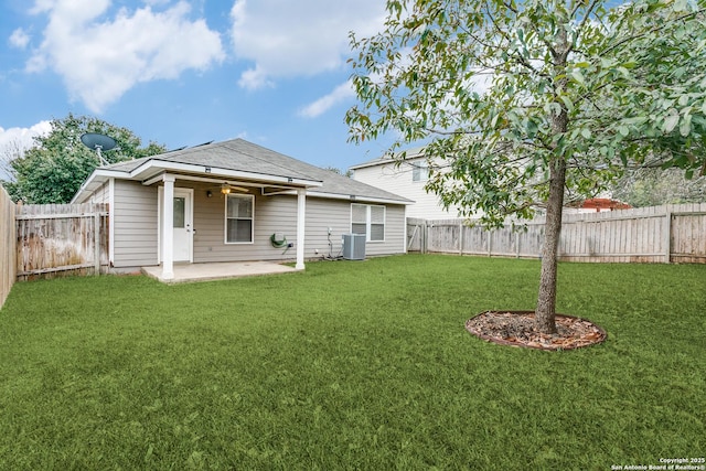 rear view of property with a lawn, a patio area, and central air condition unit