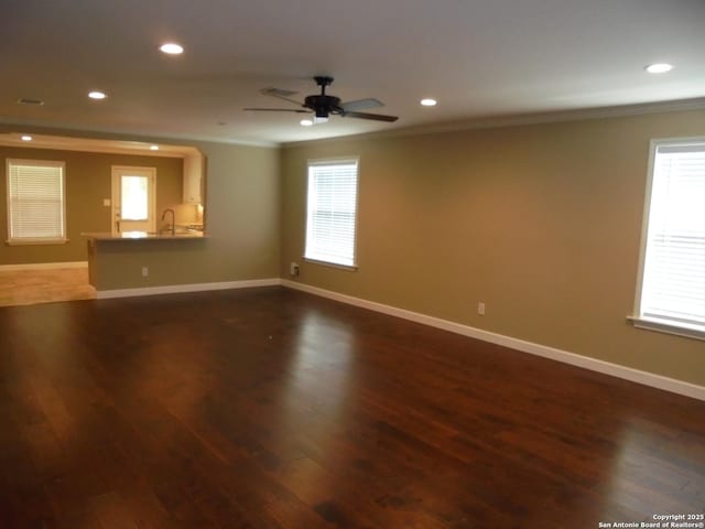 unfurnished room with crown molding, ceiling fan, and dark hardwood / wood-style flooring