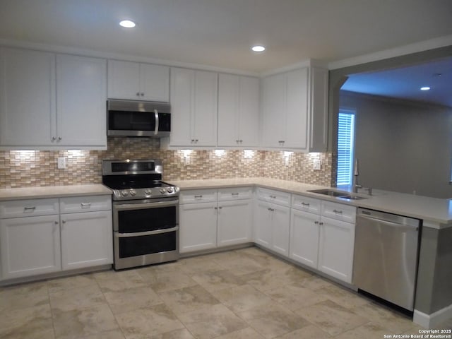 kitchen featuring stainless steel appliances, white cabinetry, and decorative backsplash