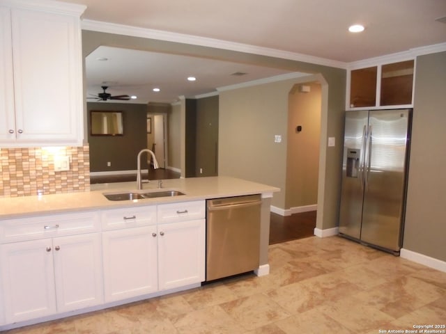 kitchen featuring white cabinetry, sink, backsplash, ceiling fan, and stainless steel appliances