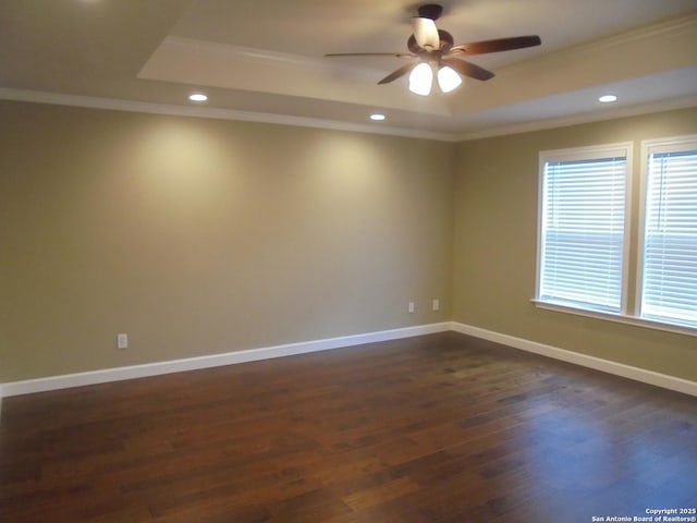 unfurnished room with crown molding, dark hardwood / wood-style flooring, and a raised ceiling