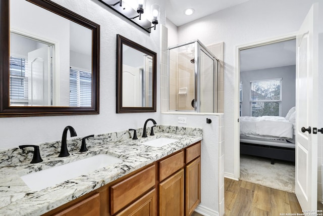 bathroom with vanity, wood-type flooring, and an enclosed shower