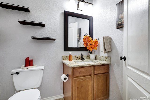 bathroom featuring toilet and vanity