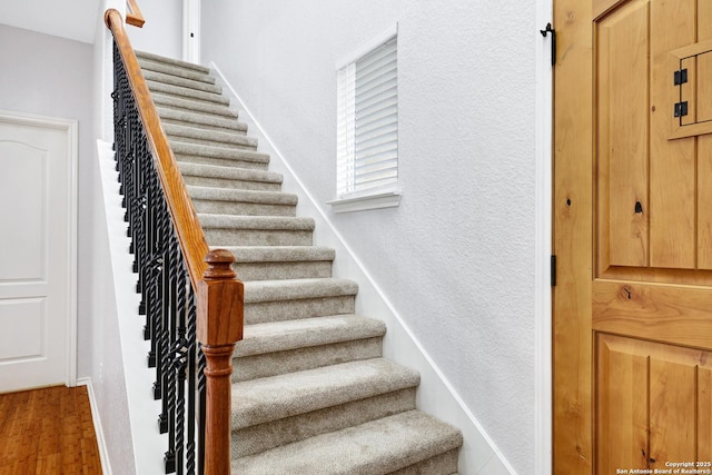 staircase featuring hardwood / wood-style flooring