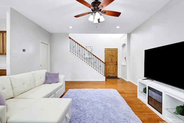 living room with ceiling fan and light wood-type flooring