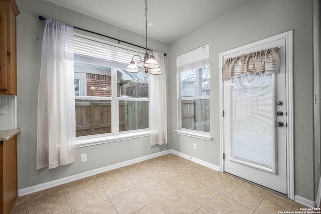 unfurnished dining area featuring a notable chandelier and light tile patterned flooring