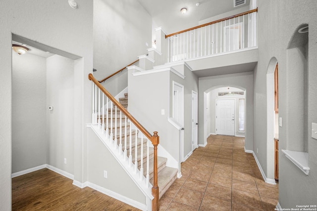 entryway featuring a high ceiling and tile patterned flooring