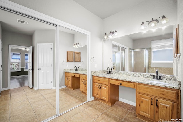 bathroom with vanity, tile patterned floors, and walk in shower