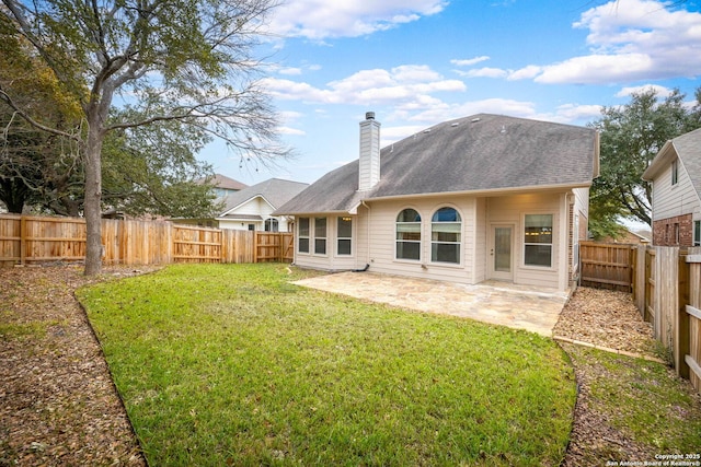 back of property featuring a patio area and a yard