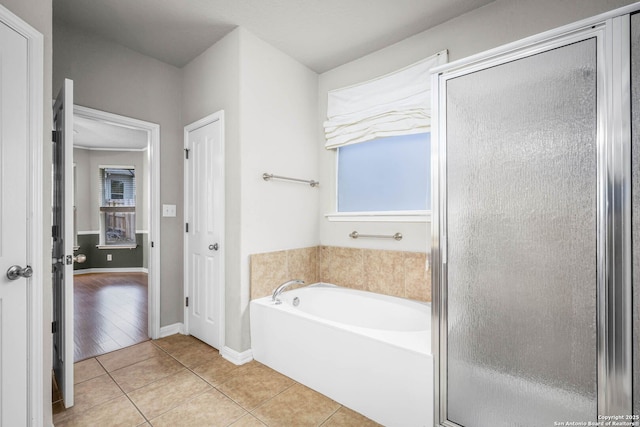 bathroom featuring tile patterned floors and shower with separate bathtub