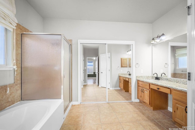 bathroom with plus walk in shower, tile patterned floors, and vanity