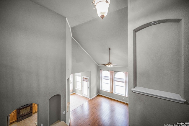 living room featuring light hardwood / wood-style floors, lofted ceiling, and ceiling fan