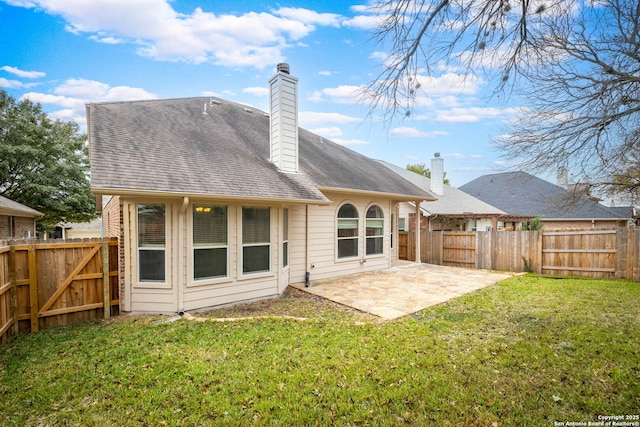 back of house featuring a patio area and a yard