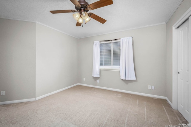 unfurnished bedroom featuring carpet, a textured ceiling, a closet, ornamental molding, and ceiling fan