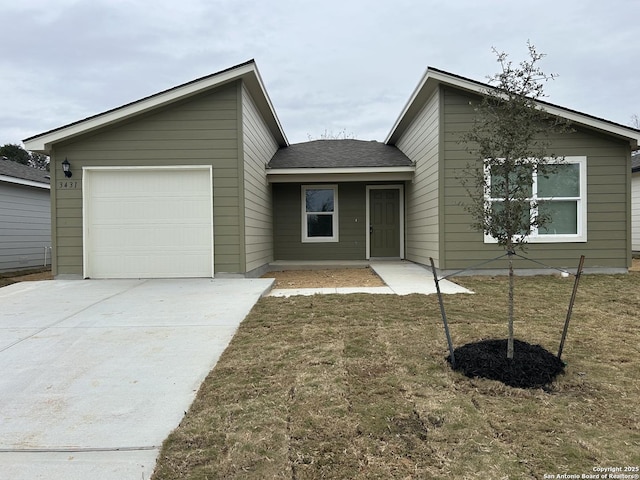 view of front of home with a garage and a front lawn