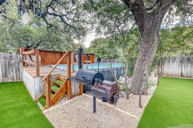 view of jungle gym with a yard and a fenced in pool