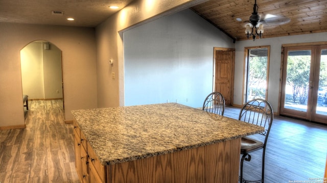 dining space with hardwood / wood-style flooring, wood ceiling, lofted ceiling, and ceiling fan